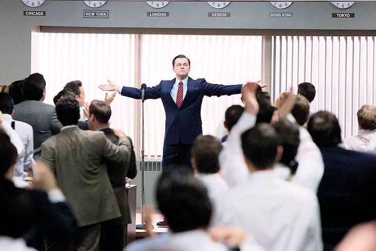 Leonardo DiCaprio (center, standing) plays Jordan Belfort in THE WOLF OF WALL STREET, from Paramount Pictures and Red Granite Pictures.