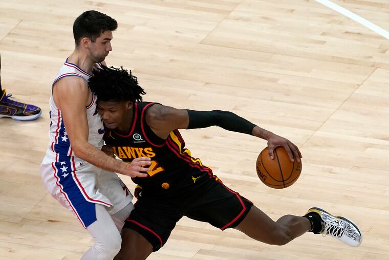 Atlanta Hawks forward De'Andre Hunter (12) drives against Sixers guard Dakota Mathias (33) during Monday's game.