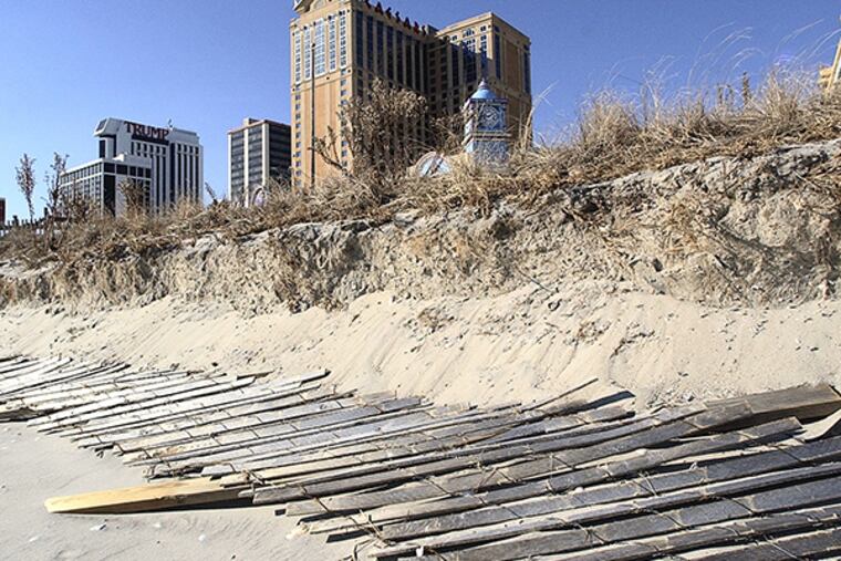 Sand dunes used to protect the boardwalk in Atlantic City, N.J., but are starting to erode. (MICHAEL PEREZ / Staff file photo)