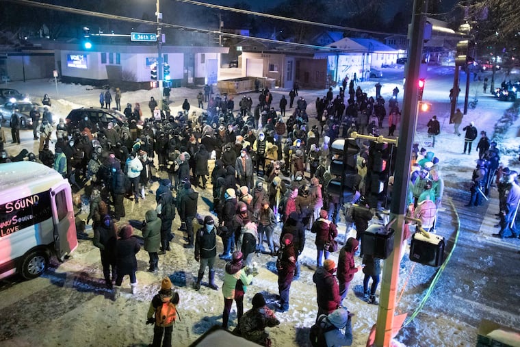 Protesters stand at the intersection of E 36th St and Cedar Ave where police took the life of someone the day before in an officer-involved shooting. The scene of the shooting was 1 mile away from where George Floyd was killed by former officer Derek Chauvin back in May.