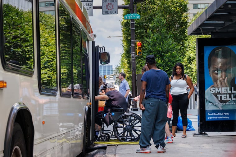 Bus patron in wheelchair is helped onto the route 17 bus at JFK Blvd and 17th Street. Cut in services will affect people that rely on bus transportation around Philadelphia. Photograph taken on Tuesday, August 12, 2025.