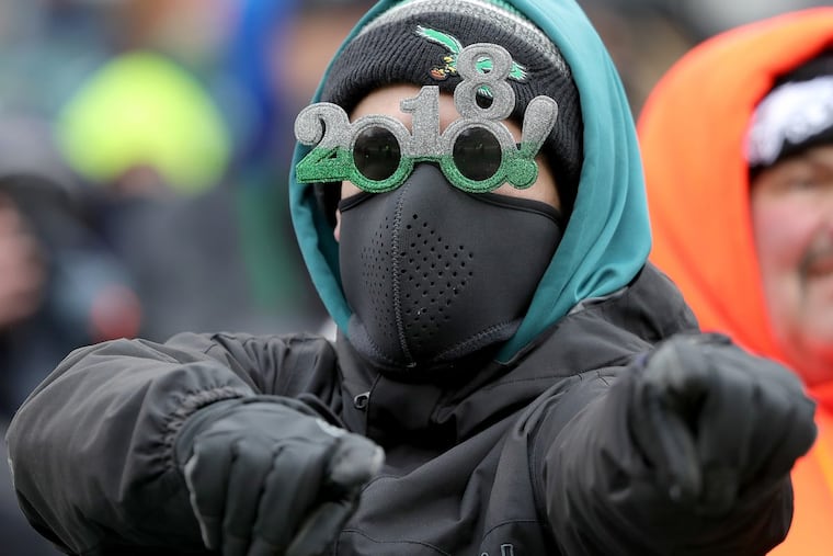 A fan wears a pair of 2018 glasses as the Philadelphia Eagles play the Dallas Cowboys in Philadelphia, PA on December 31, 2017. DAVID MAIALETTI / Staff Photographer