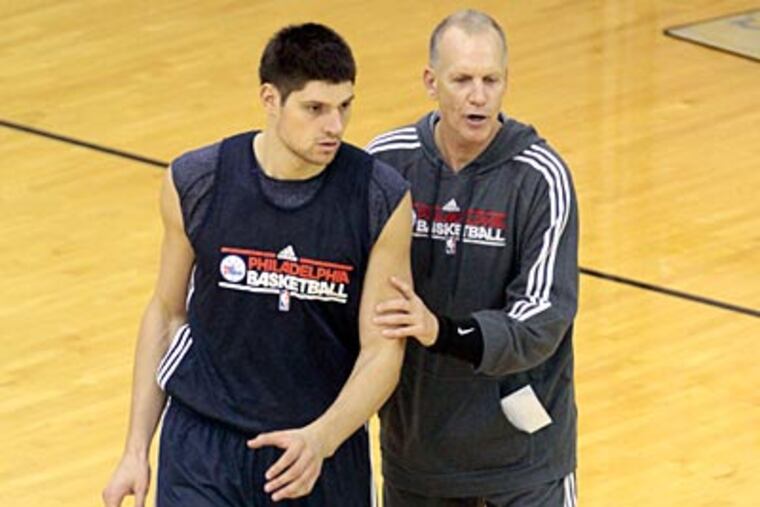 Sixers coach Doug Collins instructs rookie center Nikola Vucevic during practice on Friday. (David Swanson/Staff Photographer)