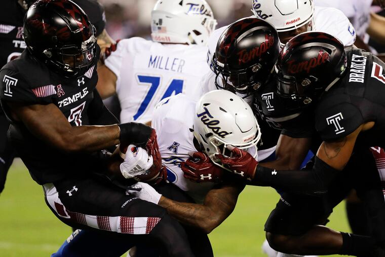 Temple linebackers Shaun Bradley (right), Sam Franklin (center) and Chapelle Russell (left) tackling Tulsa running back Shamari Brooks in 2018.