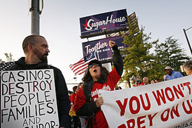 Ken Carl, who opposes construction of the casino, looks toward Beth Pulcinella of Casino Free Philadelphia as they protest outside the construction zone for Sugarhouse Casinos. (Alejandro A. Alvarez / Staff)
