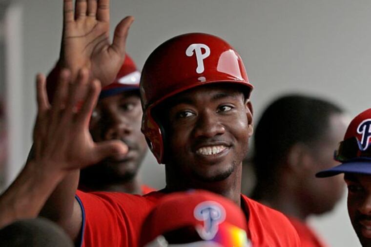 Philadelphia Phillies' Domonic Brown scores in an exhibition spring training baseball game against the Minnesota Twins, Wednesday, Feb. 27, 2013, in Fort Myers, Fla. (AP Photo/David Goldman)