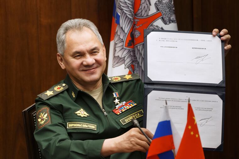 In this photo released by the Russian Defense Ministry Press Service, Russian Defense Minister Sergei Shoigu showed his signature under a roadmap for military cooperation between Russia and China during a video call with Chinese Defense Minister Wei Fenghe in Moscow on Nov. 23, 2021.