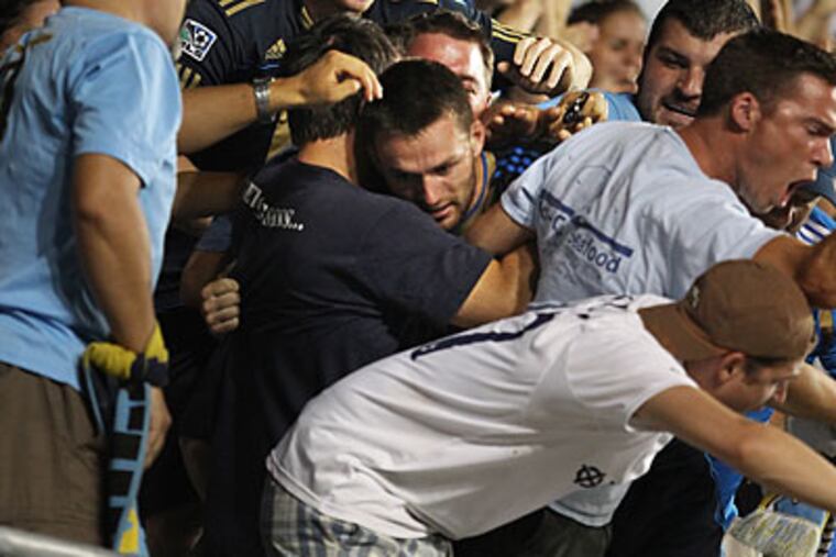 Jack McInerney celebrates with Union fans after scoring the winning goal. (Ron Cortes/Staff Photographer)