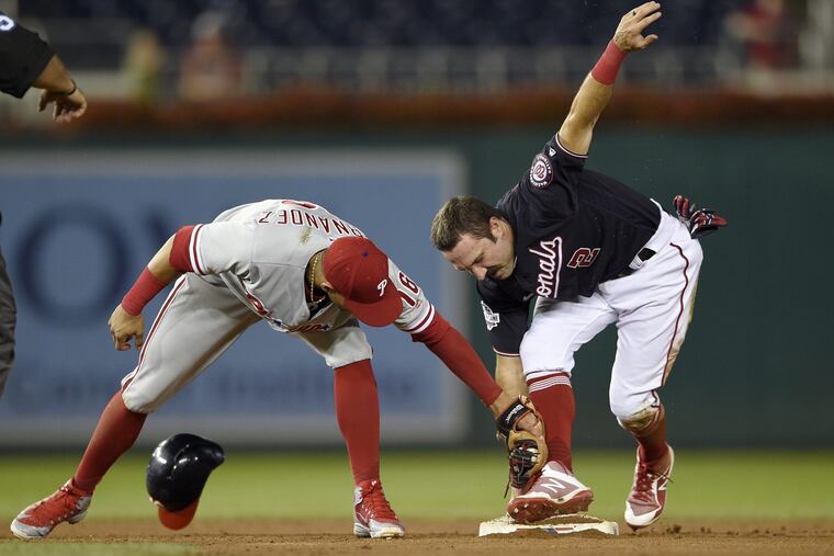 Washington Nationals' Adam Eaton, right, steals second against Philadelphia Phillies second baseman Cesar Hernandez (16) during the eighth inning of a baseball game, Tuesday, Aug. 21, 2018, in Washington.