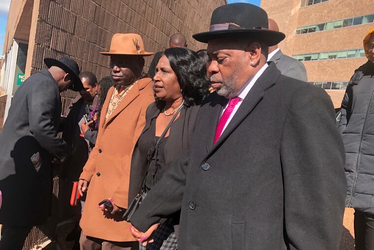 (From left) Attorney Ben Crump; Tyre Nichols’ mother, RowVaughn Wells; and stepfather, Rodney Wells, exit the courthouse on Friday after five former police officers pleaded not guilty to charges connected with Nichols' death.