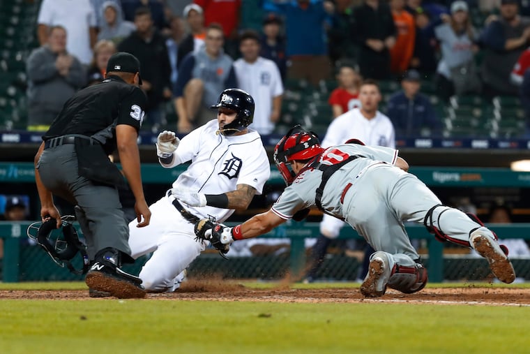 Phillies catcher J.T. Realmuto tags out Nick Castellanos at home plate in the 14th inning.