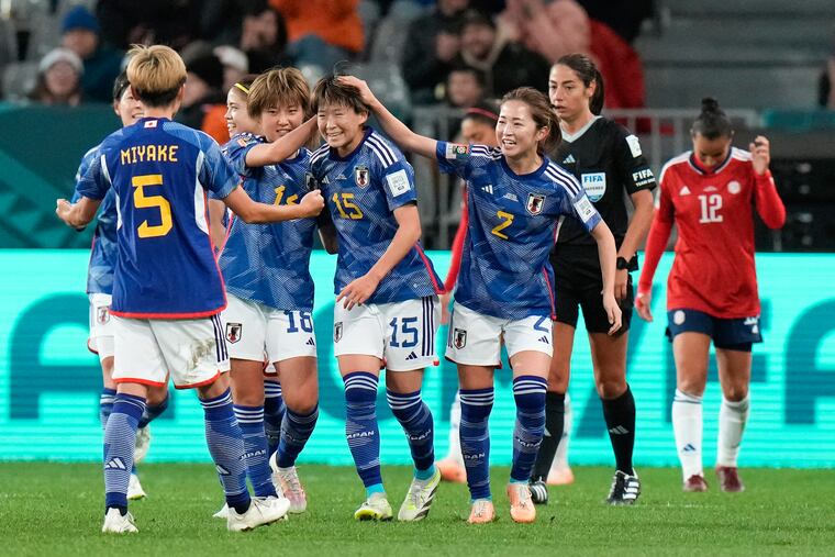 Japan's Aoba Fujino (center) is congratulated by teammates after scoring her team's second against Costa Rica.