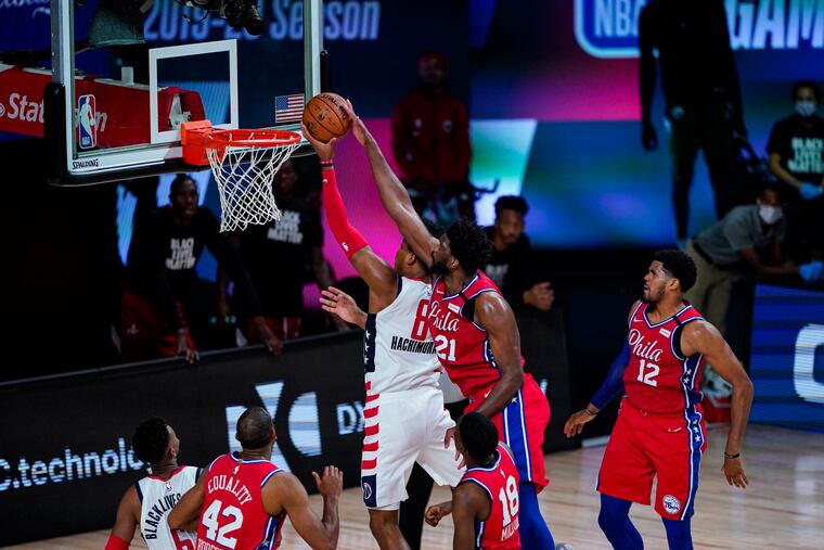 Sixers center Joel Embiid (21) comes from behind to block the shot of Washington Wizards forward Rui Hachimura (8) during the second half of Wednesday's game.