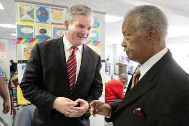 Brian Grady (left), who cites his experience as a defense lawyer and prosecutor, talks with Bill Hartie at the Tioga Senior Center.