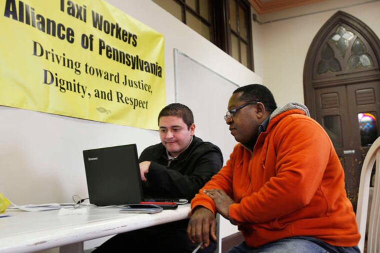 Rodrigo Giraldo (left) helps taxi driver Jimmy Solomon apply for health insurance.