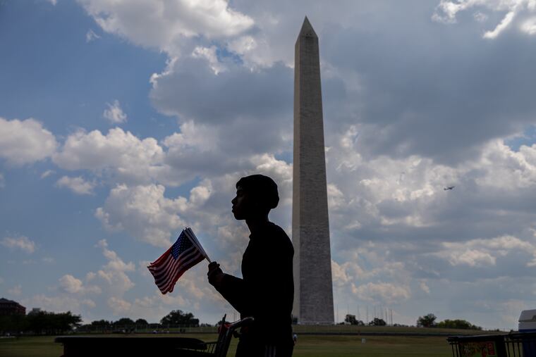 Person sells American flags near the Washington Monument on Saturday in Washington, D.C.
