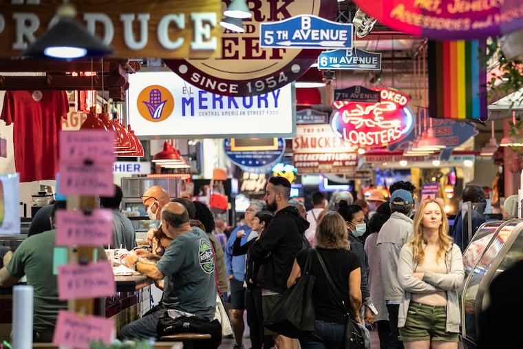Both masked and unmasked patrons roam Reading Terminal Market on Friday, June 11, 2021. The city has lifted the indoor mask mandate.