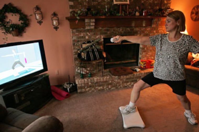 Sherry Bridson, 49, works out using the Wii Fit at her home in Milford, Michigan. (William Archie / Detroit Free Press / MCT)