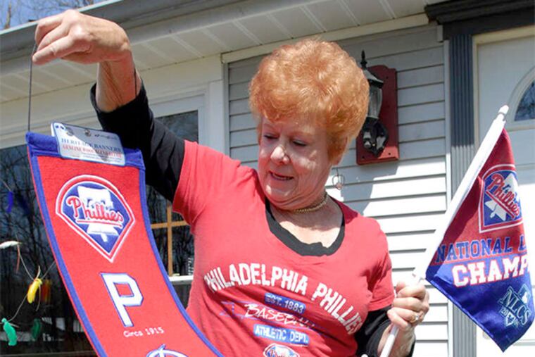 "Before we bought this place I asked the former owner if I could get the Phillies... I was going to have it written into the contract that I wouldn't but the house if I didn't get the Phillies." Tootie Eutzuy, displaying her Phillies banner and flag.