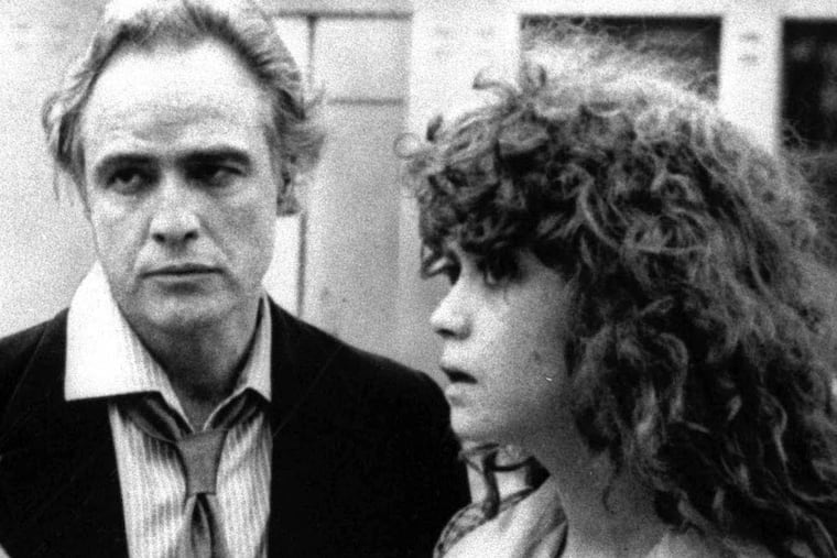 Director Bernardo Bertolucci, left, discusses a scene from "Last Tango in Paris" with leading actor Marlon Brando and actress Maria Schneider during location shooting in Paris in this undated black and white photo.