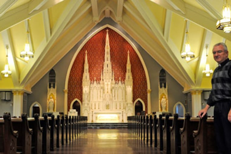 Father Paul Brandt, Pastor of Blessed Teresa of Calcutta Parish in Limerick, poses in the sancuary November 30, 2012. The church, which only had its dedication this month, has a new church building with a long history. The interior - including the altar from St. Boniface (closed in 2006) - is made up of historical artwork and sacred objects from churches long closed by the Archdiocese. ( TOM GRALISH / Staff Photographer )