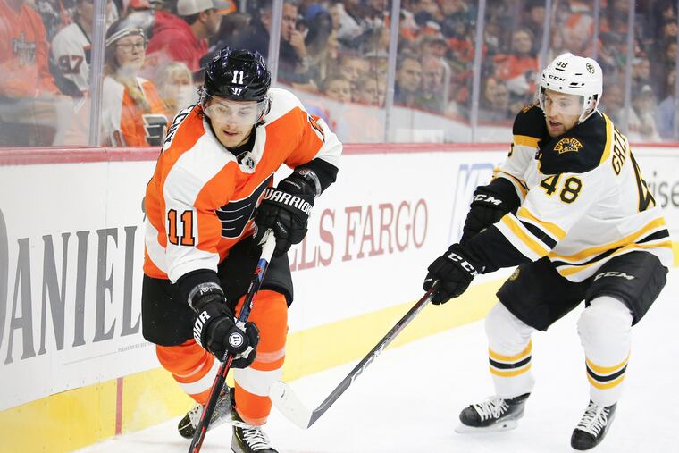 Flyers center Travis Konecny skates with the puck against Boston Bruins defenseman Matt Grzelcyk in a preseason game on Monday, September 24, 2018 in Philadelphia. YONG KIM / Staff Photographer