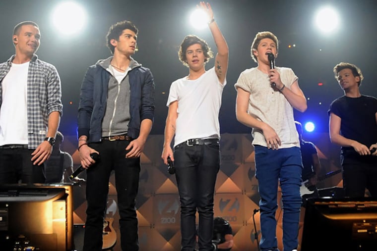 In this Dec. 7, 2012 file photo, members of One Direction, from left, Liam Payne, Zayn Malik, Harry Styles, Niall Horan, and Louis Tomlinson perform at Z100's Jingle Ball 2012 in New York. It's a crowded tour market and everyone is competing for your entertainment dollar. (Evan Agostini/Invision/AP)