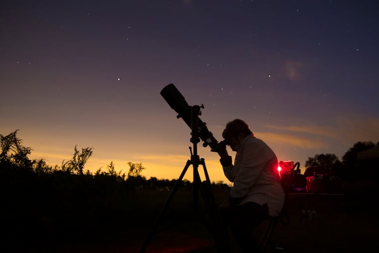 Bea Mazziotta of Broomall, PA at a telescope during a stargazing event with the Chester County Astronomical Society at the Bucktoe Creek Preserve in Avondale, PA on Sept. 29, 2018. Clouds moved in to cause an early end to the evening. CHARLES FOX / Staff Photographer