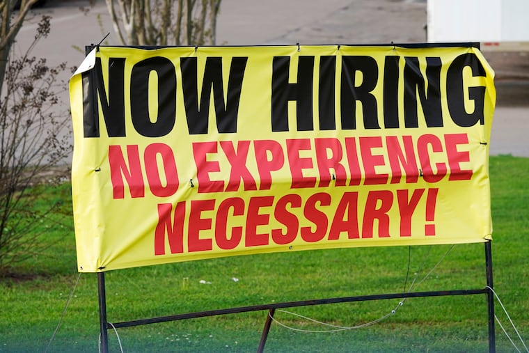 A roadside banner beckons potential employees outside a retailer in Hattiesburg, Miss.
