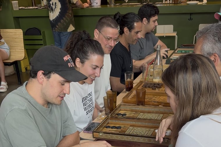 As part of Florentina Sergiou's Philly Backgammon Club, which will soon become the latest outpost of Backgammon Social, players gather to play the game during a recent pop-up. Sergiou believes young people are looking to discover fun new avenues of socialization, writes Ezra Solway.