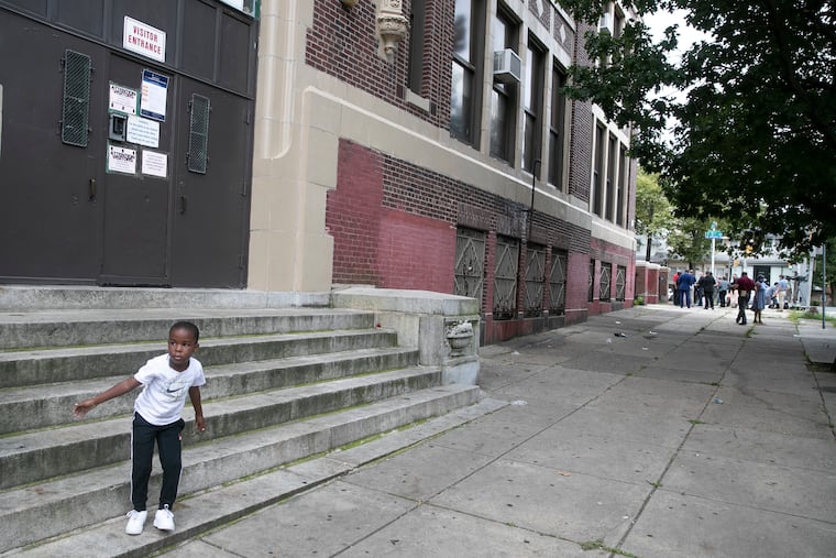 Zahkir Satchell, on his first day of Kindergarten, plays outside of the locked doors of Lowell Elementary School after picking up books with his mother, Lexus Rowe, on Wednesday, Sept. 02, 2020. The district announced Tuesday it will not start transitioning students back into the classroom Nov. 30 as planned.
