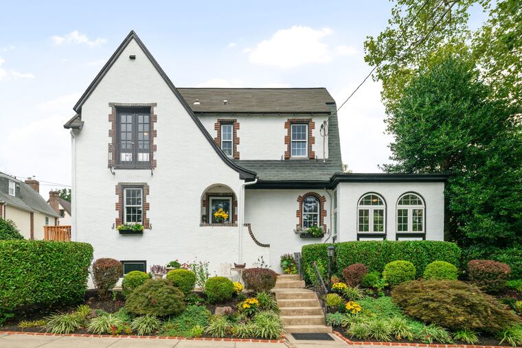 The twin, built in 1925, has original hardwood floors, wood-burning fireplace, and cast-iron radiators, but has been updated with central air-conditioning and new wiring.