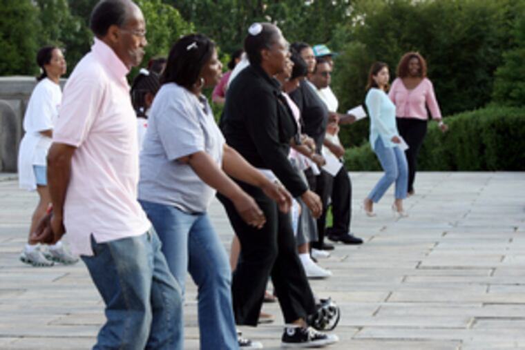 Salsa dancers show their stuff in front of the Philadelphia Museum of Art.