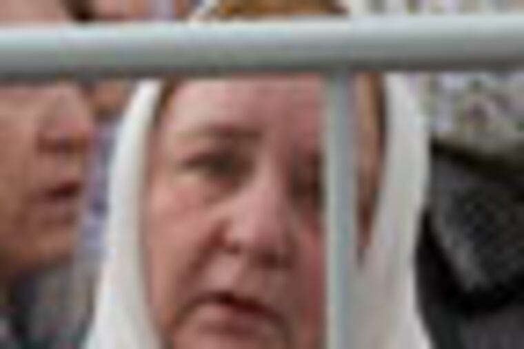 Russian Orthodox believers pray outside the Christ the Savior Cathedral in Moscow, Russia, Sunday, April 22, 2012. Thousands have gathered at Moscow's main cathedral to pray for the defense of the Russian Orthodox Church. Patriarch Kirill called on worshippers at Sunday's service to pray "for our faith, our church, our sacred objects and our fatherland." (AP Photo/Ivan Sekretarev)