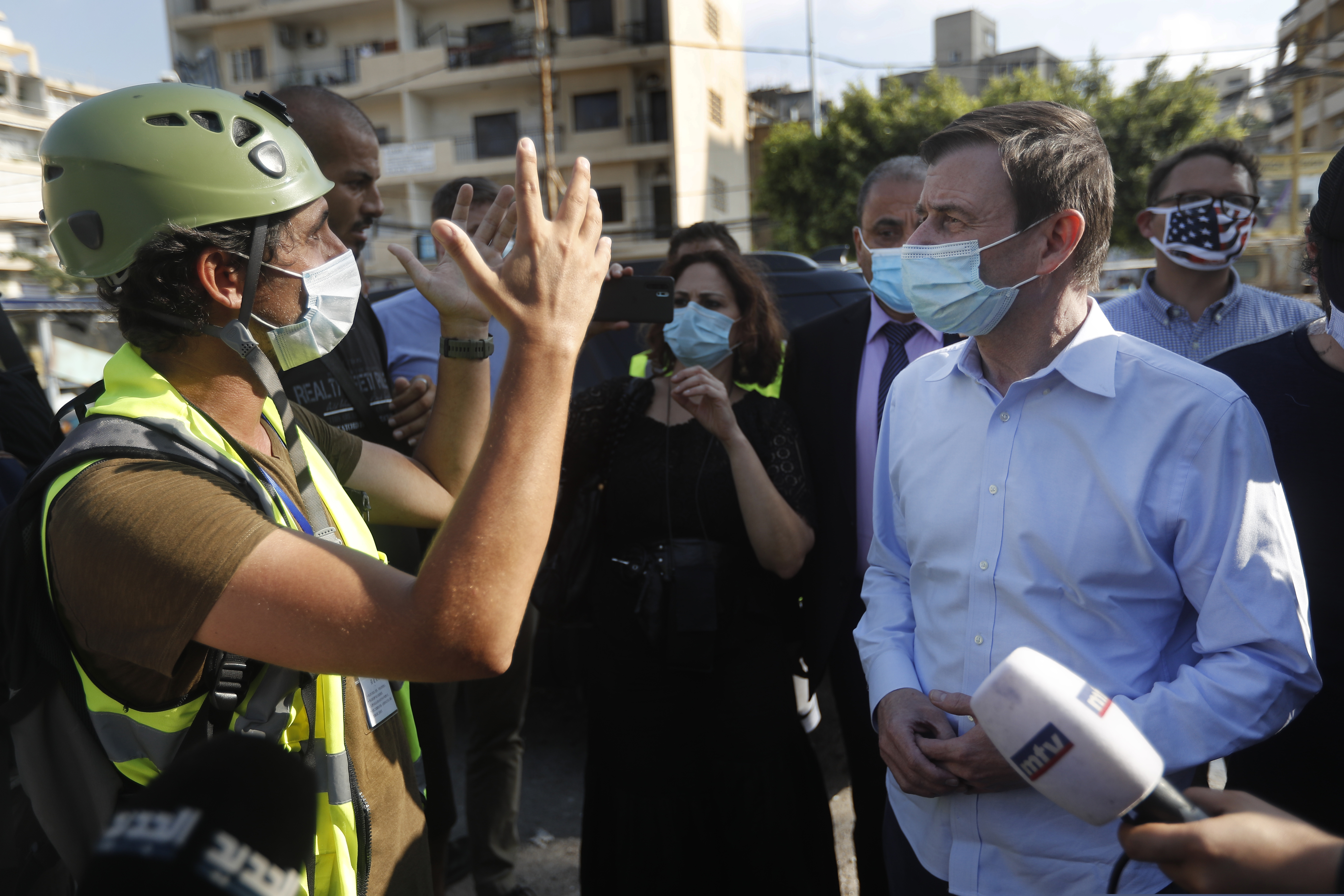 U.S. Undersecretary of State for Political Affairs David Hale, right, listens to an NGO volunteer during his visit to a main gathering point for volunteers, near the site of last week's explosion that hit the seaport of Beirut, Lebanon on Thursday.