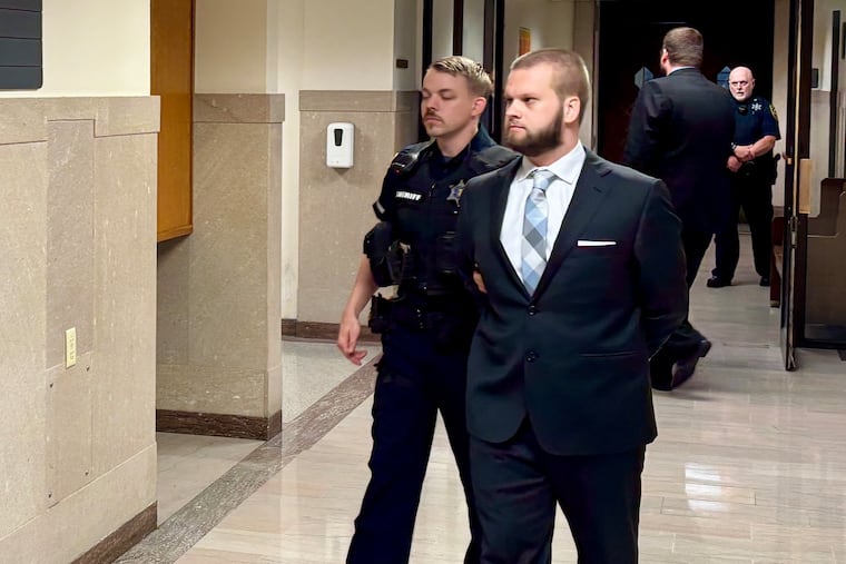 Michael Dutkiewicz is escorted out of a courtroom in the Montgomery County Courthouse. Dutkiewicz is on trial this week in the murder of Alyssa Wiest, his girlfriend.