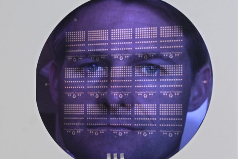 Graphene Frontiers CEO Mike Patterson is seen reflected in a diagnostic chip wafer in his company's lab in Philadelphia on May 19, 2014. ( DAVID MAIALETTI / Staff Photographer )