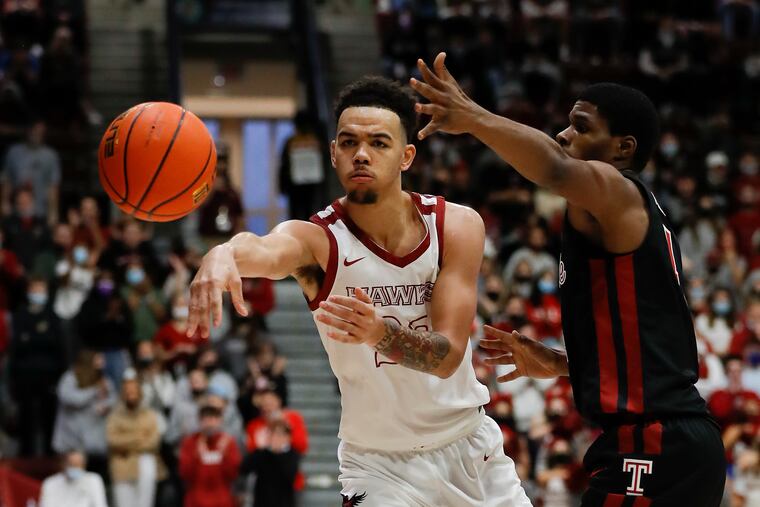 Saint Joseph's guard Jordan Hall passes the basketball past Temple guard Hysier Miller on Dec. 11..