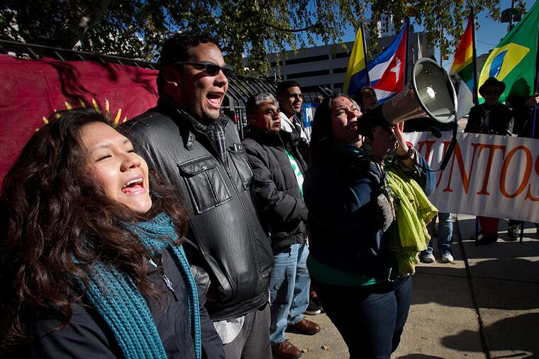 Juntos members (from left) Olivia Vasquez, Miguel Andrade and Erika Almiron during a rally outside immigration offices at North 16th and Callowhill streets on Friday, November 21, 2014. ( ALEJANDRO A. ALVAREZ / STAFF PHOTOGRAPHER )