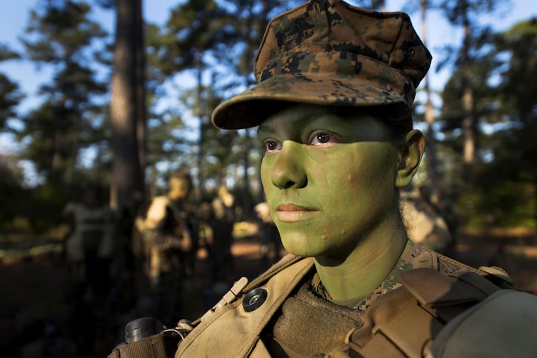 Pfc. Christina Fuentes Montenegro prepares to hike to her platoon's defensive position during patrol week of Infantry Training Battalion near Camp Geiger, N.C., on Oct. 31, 2013.