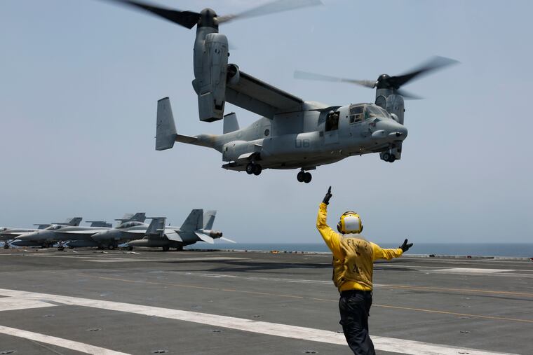 FILE -In this image provided by the U.S. Navy, Aviation Boatswain's Mate 2nd Class Nicholas Hawkins, signals an MV-22 Osprey to land on the flight deck of the USS Abraham Lincoln in the Arabian Sea. When the U.S. military took the extraordinary step of grounding its fleet of V-22 Ospreys this week, it wasn't reacting just to the recent deadly crash of the aircraft off the coast of Japan. The aircraft has had a long list of problems in its short history.