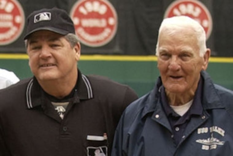 Jerry Crawford stands next to his father before umpiring the final game at the Vet. Shag Crawford worked the first.