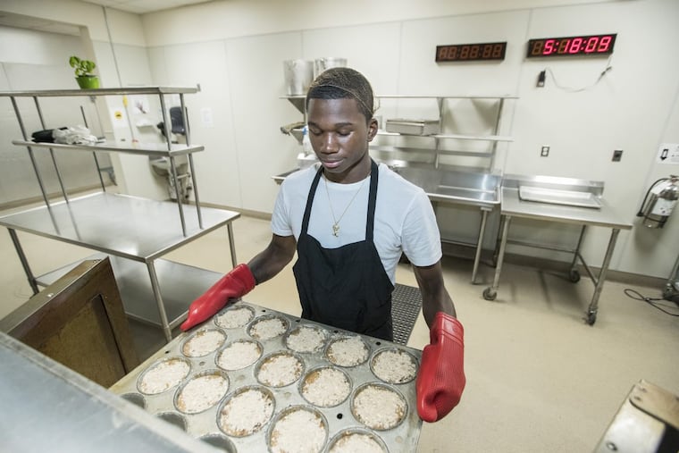 Zaire White puts a batch of Rebel Crumbles into the oven.