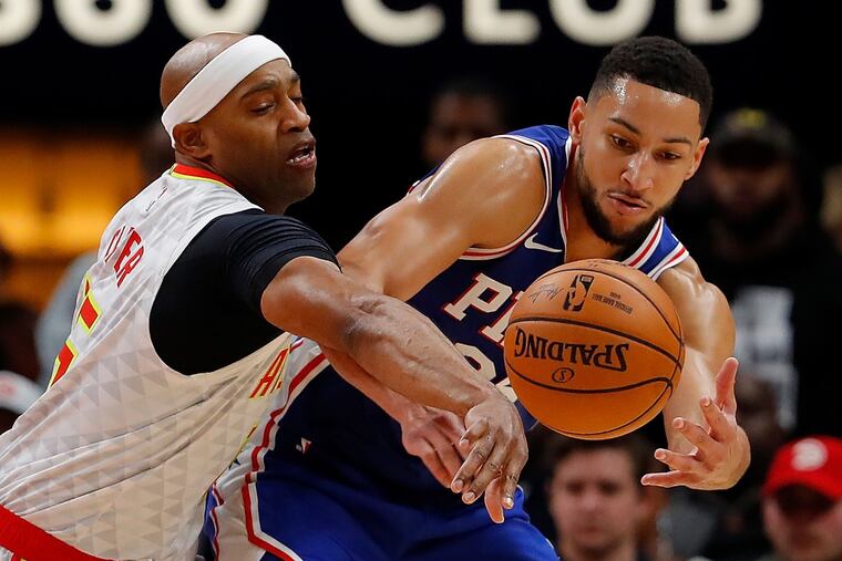 The Hawks' Vince Carter, left, knocks the ball loose from the 76ers' Ben Simmons.