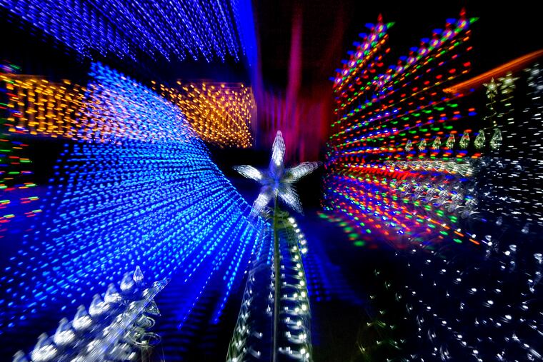 December 28, 2020: A holiday light display in a Chester County front yard is photographed with a "zoom burst" technique, an effect created by using a zoom lens and changing the focal length while the shutter is open during a long exposure.