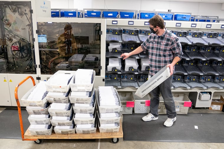A worker sorts Chester County mail ballots.