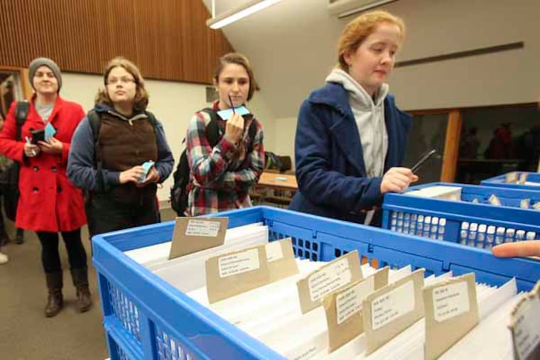 RRXHONOR19P---Bryn Mawr college have one of the oldest honor codes in the country and perhaps their codes are never more visible as they will be this week - exam week. Bryn Mawr students take their exams when they want, either in an unproctored classroom or in some cases in their dorm room. It's all on the honor system. Proctor Emily Tong, right off camera hands out the exams. Monday, December 17, 2012. ( STEVEN M. FALK/ Staff Photographer )