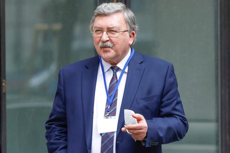 In this April 20 photo, Russia's Governor to the International Atomic Energy Agency, IAEA, Mikhail Ulyanov, smoked a cigarette in front of the Grand Hotel Wien where closed-door nuclear talks with Iran took place.