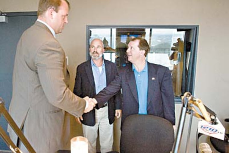 After the debate, host Michael Smerconish watches as Jon Runyan (left) and John Adler shake hands. (Clem Murray / Staff)