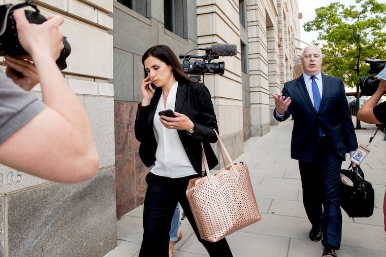 File - In this May 9, 2018 file photo, Attorneys Eric Dubelier, right, and Katherine Seikaly, left, representing Concord Management and Consulting LLC, walk out of federal court in Washington, after pleading not guilty on behalf of the company, which has been charged as part of a conspiracy to meddle in the 2016 US presidential election. A federal judge on Monday reprimanded Dubelier, saying his references to Looney Tunes and “Animal House” in recent court filings are inappropriate. (AP Photo/Andrew Harnik)